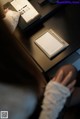 A person sitting at a desk with a calculator and a notepad.