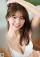 a japanese woman in a white bra top is posing for the camera