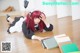 A woman laying on the floor with books.