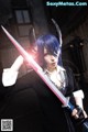 A woman with blue hair holding a sword.