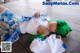 A woman with green hair laying on a wooden floor.