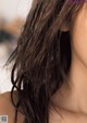 A close up of a woman's hair with wet hair.