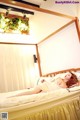 A woman laying on top of a bed in a bedroom.