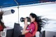 A woman taking a picture of herself on a boat.