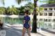 A woman in a polka dot swimsuit walking on the beach.