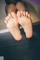 A woman's feet in a bathtub with water on them.