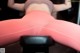 A woman in pink leggings is sitting on a bench.