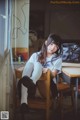 A woman sitting on a chair in a room.