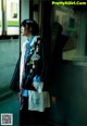 A woman standing in front of a train window.