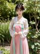 A woman in a pink and blue hanbok standing in a garden.