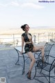 A woman sitting on a chair on top of a roof.