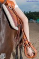 A woman sitting on top of a brown horse.