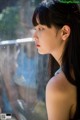 A woman looking out of a window in the rain.