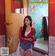 A woman standing in front of a mirror in a bathroom.