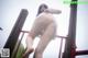 A woman in a white dress is standing on a playground.