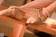 A close up of a woman's feet on a wooden table.