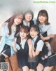 A group of young women sitting on top of a couch.