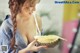 A woman holding a durian in her hands.