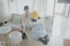 A woman sitting in a hanging chair in a room.