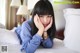 A woman laying on a bed with her hand on her face.